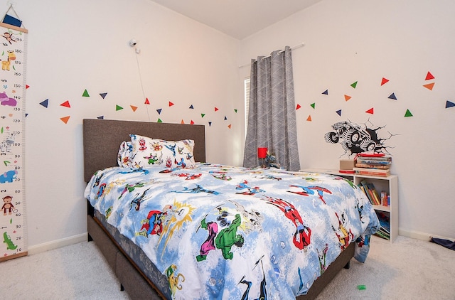 bedroom with light carpet and baseboards