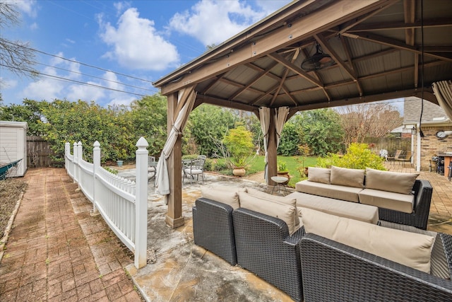 view of patio / terrace with a gazebo, fence, and an outdoor living space