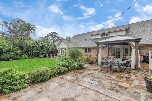 back of house with a lawn, a patio, french doors, a gazebo, and brick siding