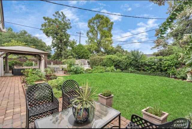 view of yard with fence, a patio, and a gazebo