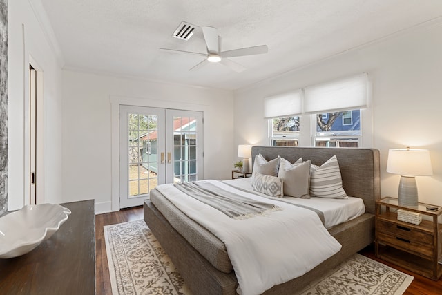 bedroom with access to exterior, french doors, dark wood finished floors, and ornamental molding