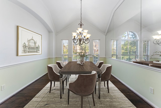 dining room featuring vaulted ceiling, dark wood finished floors, a wealth of natural light, and a notable chandelier