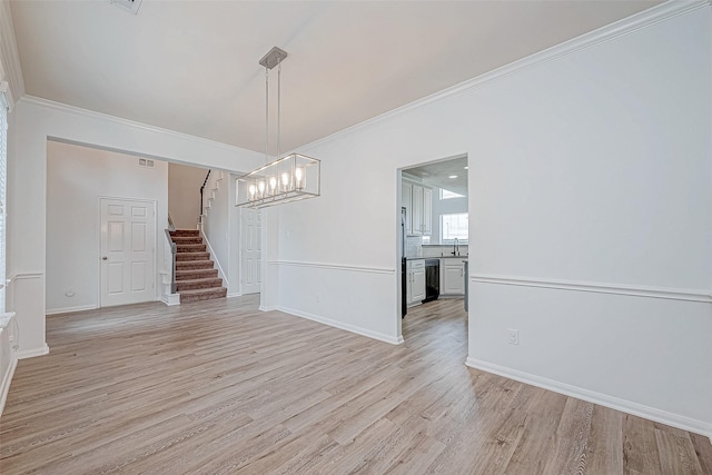 unfurnished dining area with stairs, light wood finished floors, a sink, and ornamental molding