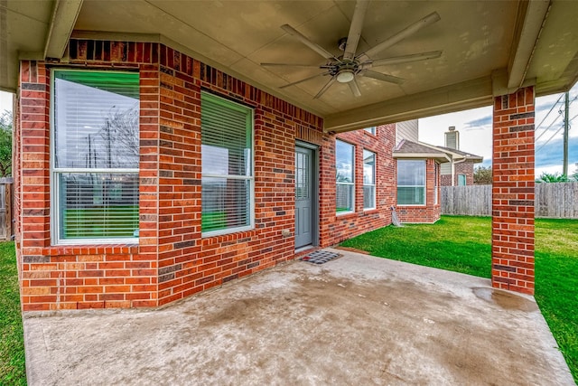 view of patio / terrace with fence and a ceiling fan