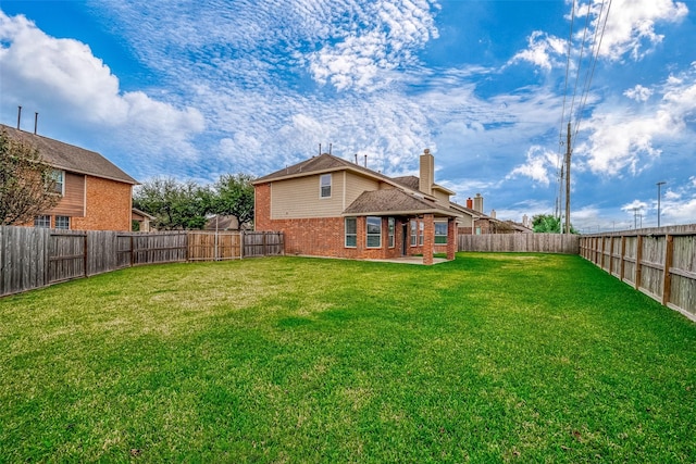 view of yard with a fenced backyard and a patio