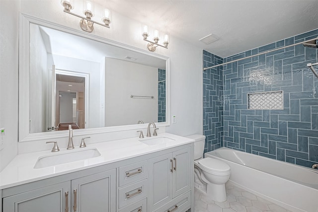 bathroom featuring bathing tub / shower combination, a sink, toilet, and tile patterned floors