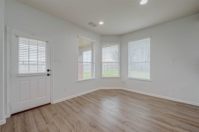 entrance foyer featuring plenty of natural light, recessed lighting, light wood-type flooring, and baseboards