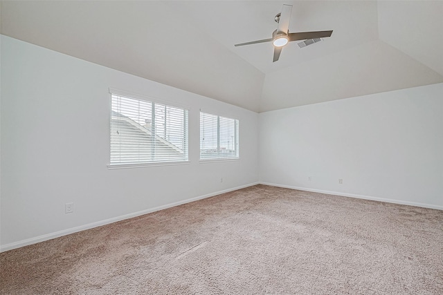 unfurnished room with ceiling fan, carpet floors, visible vents, baseboards, and vaulted ceiling