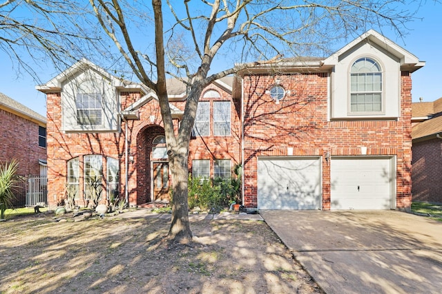 traditional-style house with a garage, brick siding, and driveway