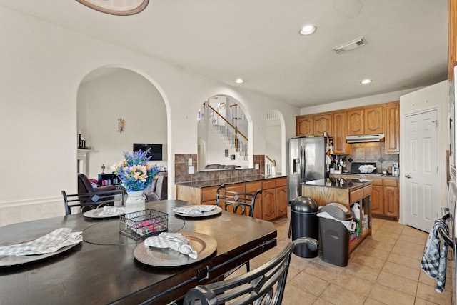 dining space featuring stairway, light tile patterned flooring, visible vents, and recessed lighting