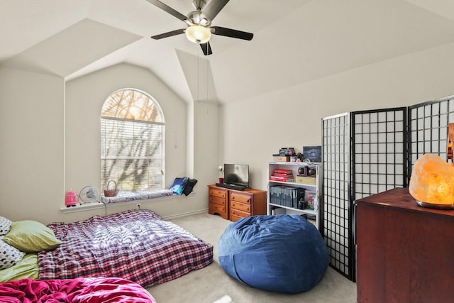 carpeted bedroom featuring lofted ceiling and a ceiling fan