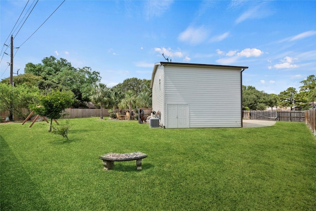 view of yard with cooling unit and a fenced backyard