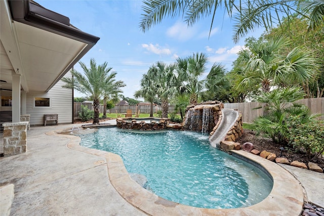 view of pool featuring a patio area, a fenced backyard, and a pool with connected hot tub