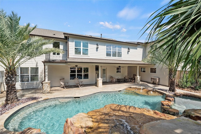 exterior space with a patio area, fence, and a pool with connected hot tub