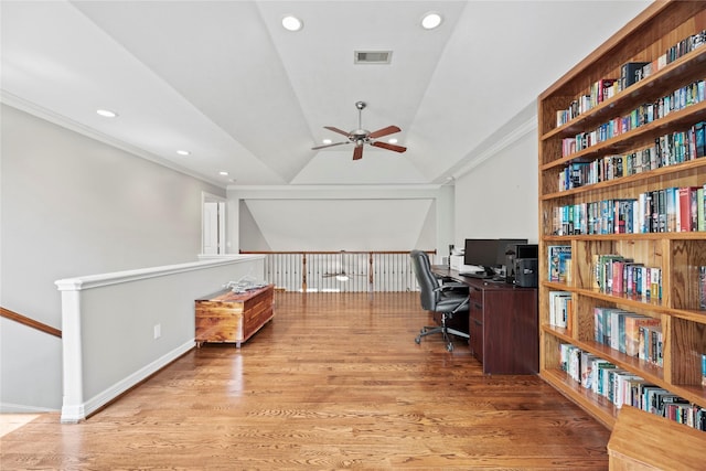 office featuring recessed lighting, visible vents, light wood-style floors, vaulted ceiling, and crown molding