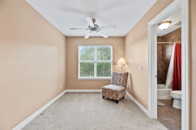 living area featuring ceiling fan, carpet, visible vents, and baseboards