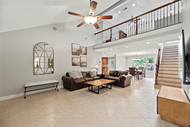 living room featuring light tile patterned floors, stairs, baseboards, and high vaulted ceiling