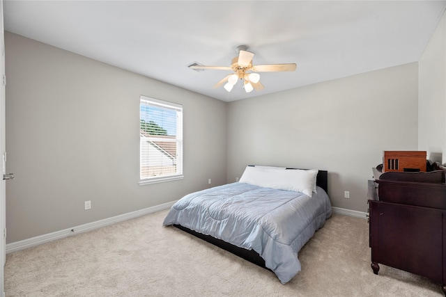 bedroom with light carpet, ceiling fan, and baseboards