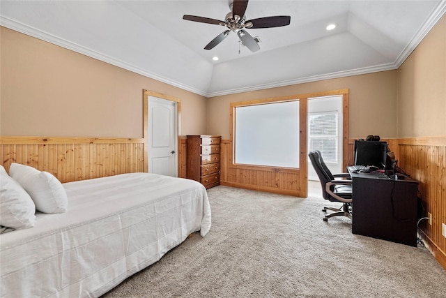 bedroom featuring wooden walls, wainscoting, lofted ceiling, ornamental molding, and carpet flooring