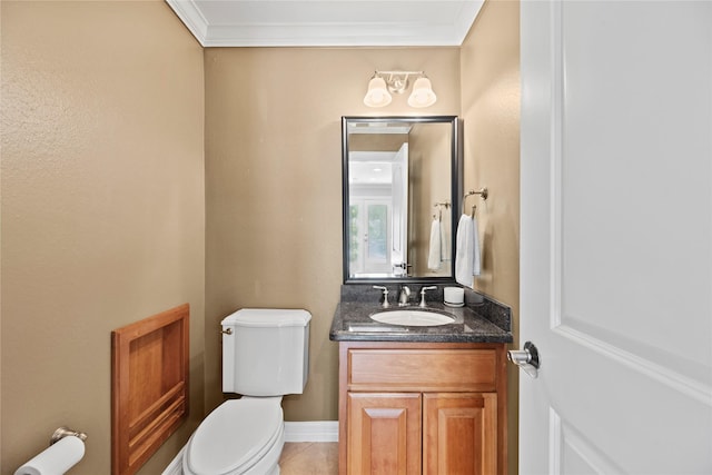 bathroom with toilet, tile patterned floors, vanity, and crown molding