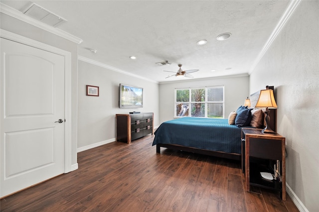 bedroom featuring crown molding, dark wood-style flooring, visible vents, and baseboards