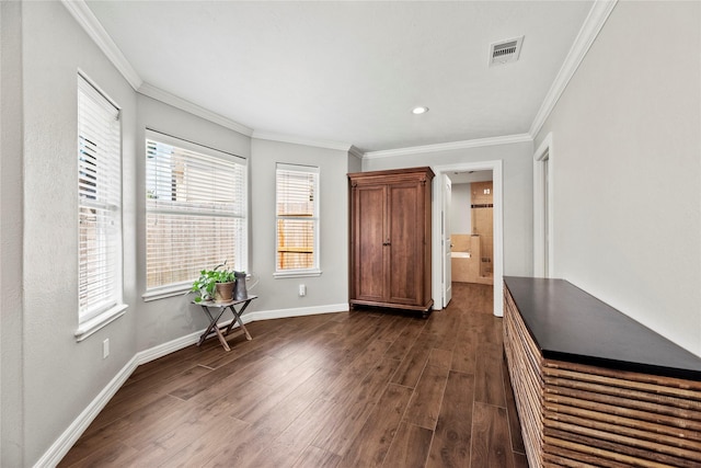 unfurnished bedroom featuring baseboards, visible vents, dark wood-style flooring, crown molding, and recessed lighting