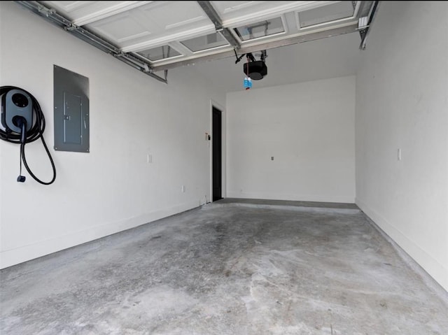 garage with baseboards, electric panel, and a garage door opener