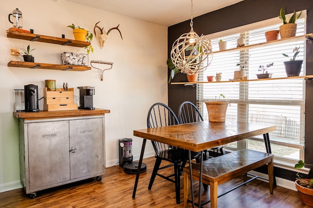 dining space featuring plenty of natural light, baseboards, and wood finished floors