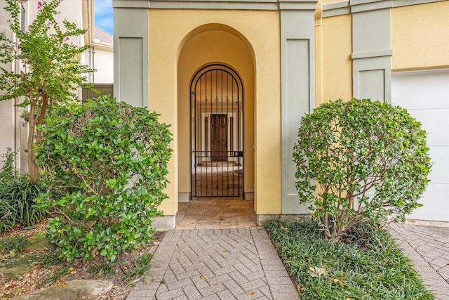 doorway to property featuring stucco siding