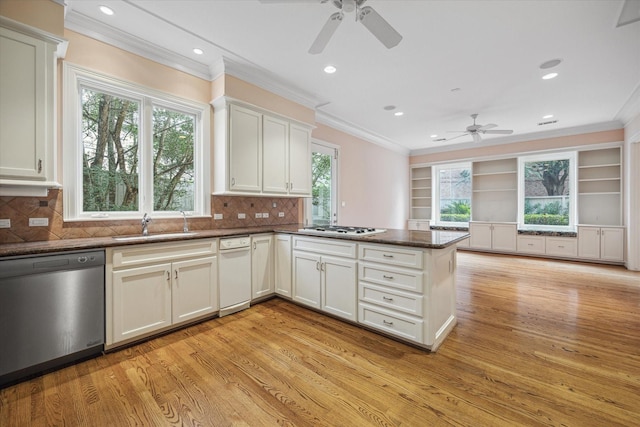 kitchen with gas stovetop, ornamental molding, white cabinetry, dishwasher, and a peninsula