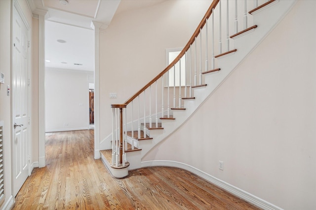 stairway with baseboards and wood finished floors