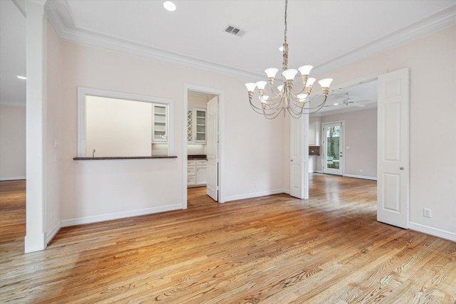 unfurnished dining area featuring visible vents, crown molding, light wood-style flooring, and baseboards