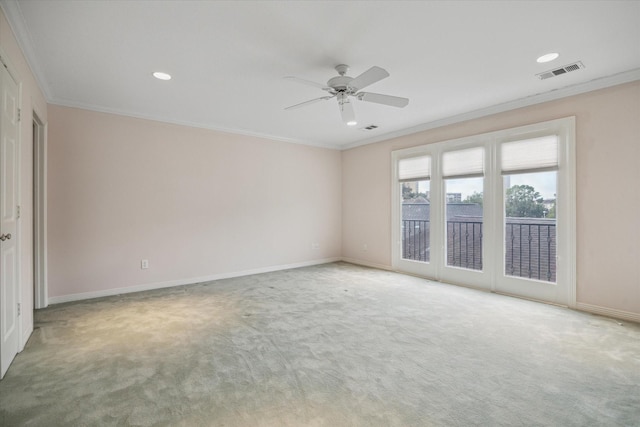 empty room with visible vents, crown molding, light carpet, and baseboards