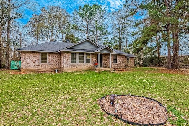 ranch-style home featuring a front yard and brick siding