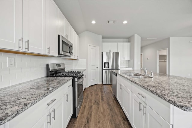 kitchen featuring an island with sink, white cabinetry, appliances with stainless steel finishes, and a sink