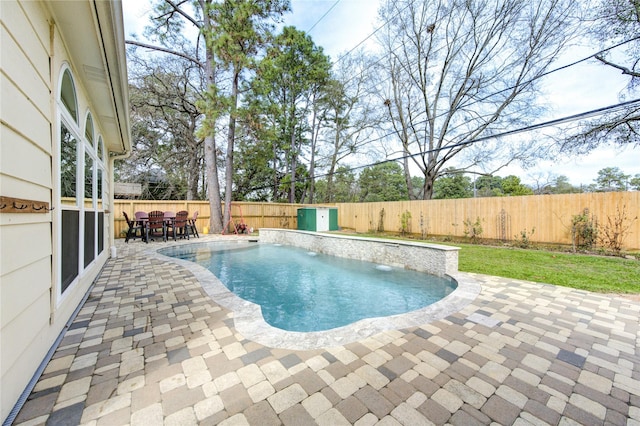 view of pool with a patio, outdoor dining space, a fenced backyard, and a fenced in pool