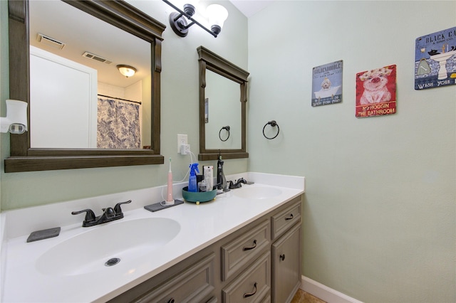 full bathroom with double vanity, a sink, and visible vents