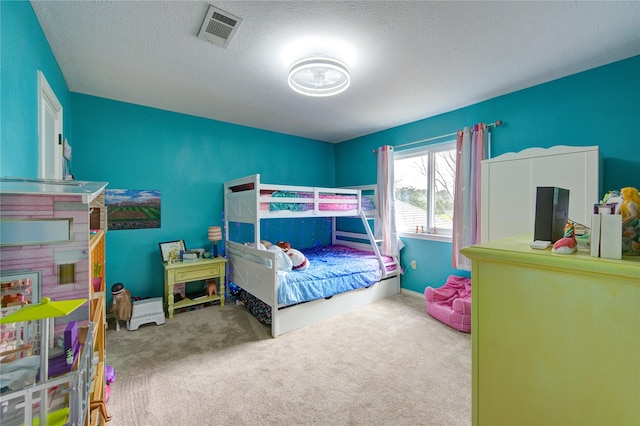 carpeted bedroom featuring visible vents, a textured ceiling, and baseboards