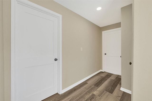 hallway with recessed lighting, wood finished floors, and baseboards
