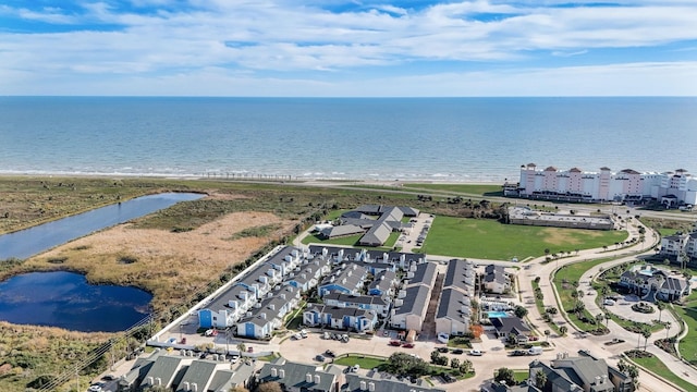 bird's eye view with a water view and a beach view