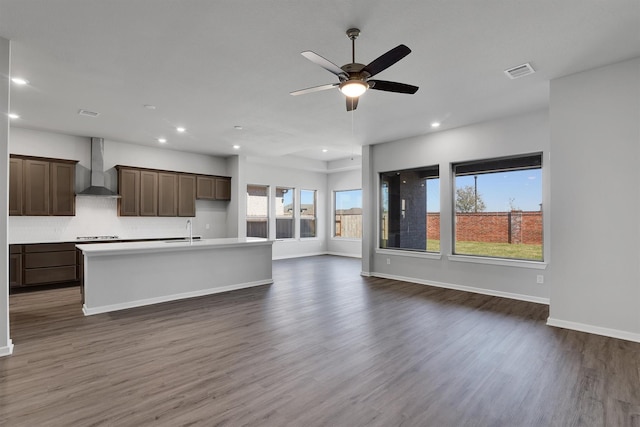 2920 Apple Rose, Katy, TX 77493 - kitchen featuring visible vents, dark wood-type flooring, a kitchen island with sink, open floor plan, and wall chimney exhaust hood