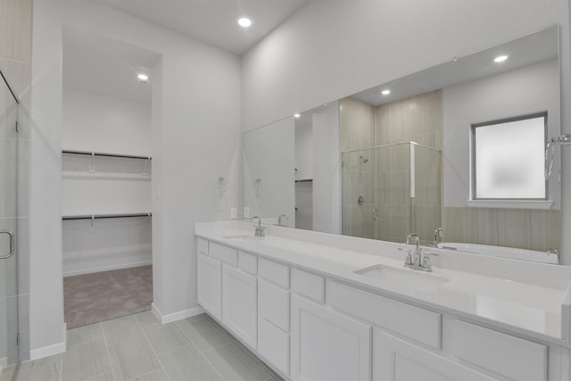 2920 Apple Rose, Katy, TX 77493 - bathroom with a sink, a walk in closet, a stall shower, and double vanity