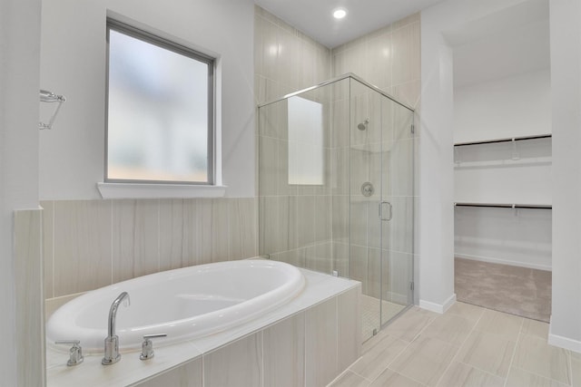2920 Apple Rose, Katy, TX 77493 - full bathroom featuring baseboards, a spacious closet, a bath, and a shower stall