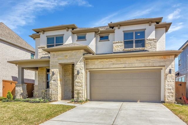 prairie-style house featuring stone siding, stucco siding, an attached garage, and concrete driveway