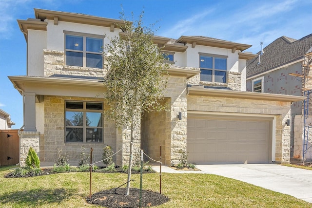 prairie-style home with an attached garage, stone siding, and driveway