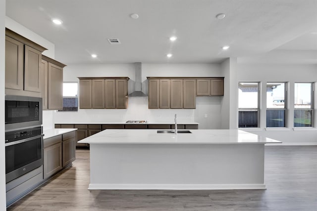 2920 Apple Rose, Katy, TX 77493 - kitchen with oven, visible vents, a sink, wall chimney range hood, and built in microwave