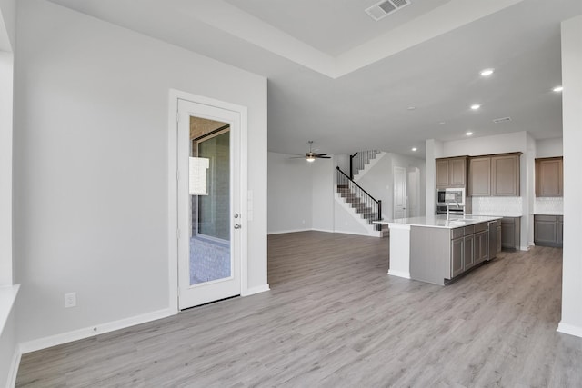 2920 Apple Rose, Katy, TX 77493 - kitchen featuring visible vents, light countertops, light wood-type flooring, and open floor plan