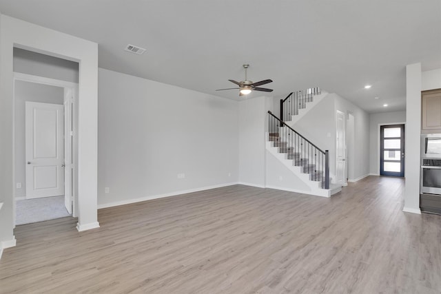 2920 Apple Rose, Katy, TX 77493 - unfurnished living room with visible vents, recessed lighting, stairway, light wood finished floors, and baseboards