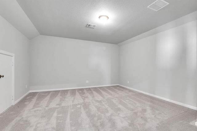 2920 Apple Rose, Katy, TX 77493 - carpeted empty room featuring baseboards, visible vents, a textured ceiling, and lofted ceiling