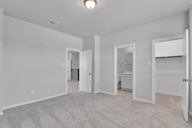 2920 Apple Rose, Katy, TX 77493 - unfurnished bedroom with visible vents, light carpet, ensuite bath, baseboards, and a spacious closet
